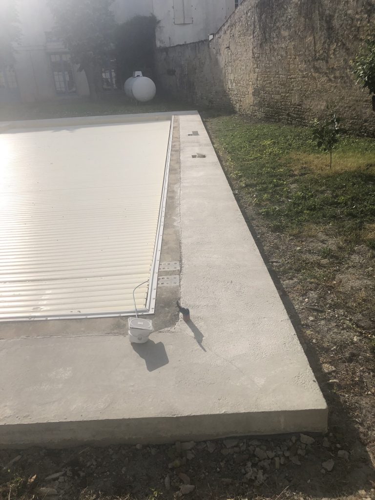 Pose des margelles et dallage en pierre autour d'une piscine à MARANS